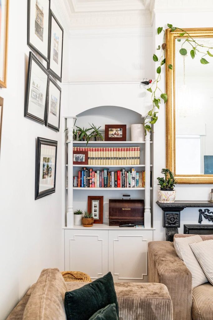 Elegant living room corner featuring a bookshelf, framed art, and plush seating for a cozy ambiance.